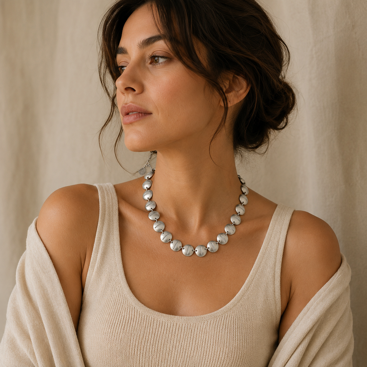 Silver-tone necklace with reflective oval disc links.