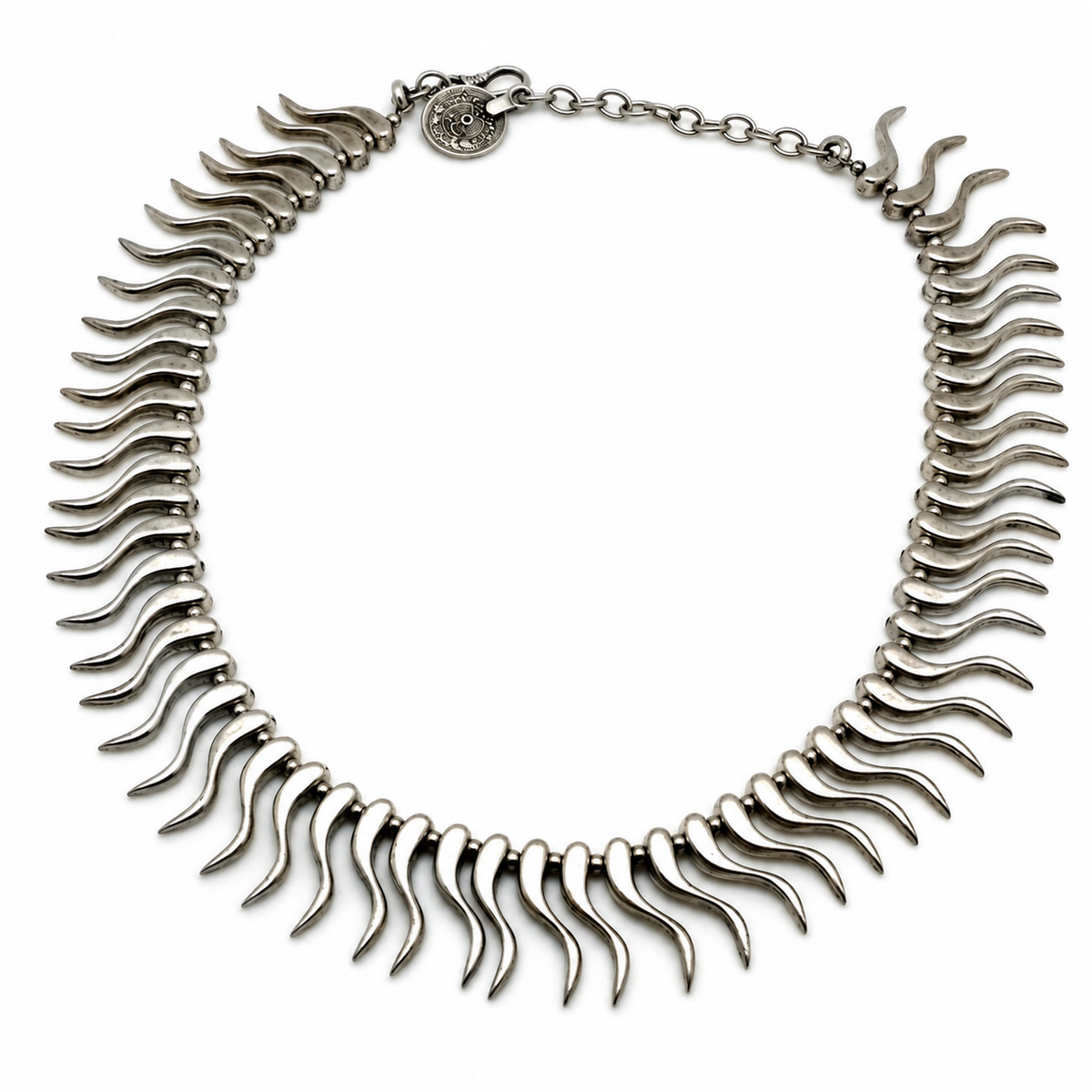 Silver-tone collar necklace with curved spike links arranged in a bold semicircle.