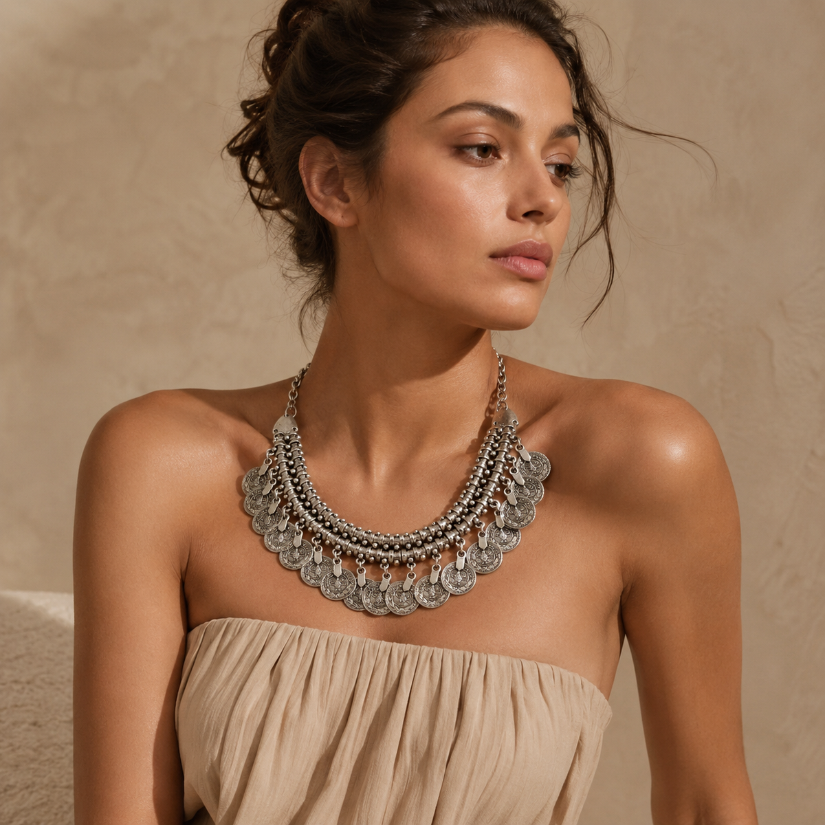 Silver-tone collar necklace with dangling coin fringe and textured detail.