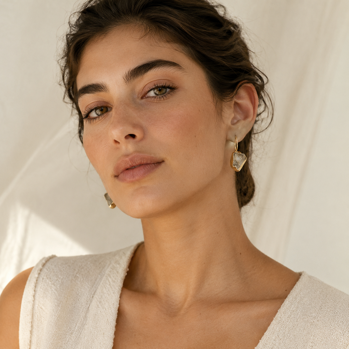 Raw amethyst drop earrings with a polished gold-plated finish.