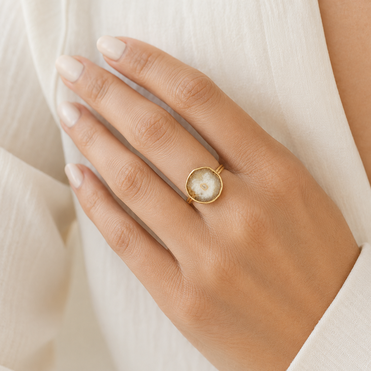 Gold-plated ring with a solar quartz slice shown from the front.
