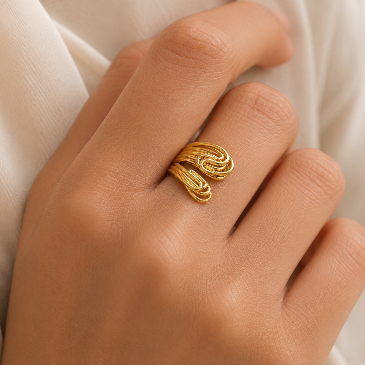 Gold-plated multi band knot statement ring shown from the front.