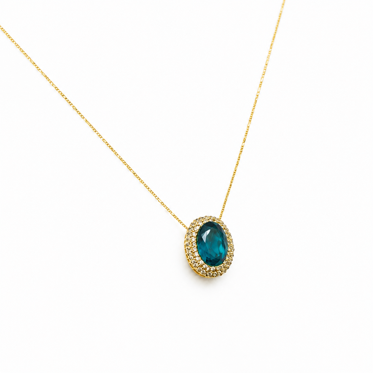 Angle view of a gold-tone necklace with a green oval pendant.