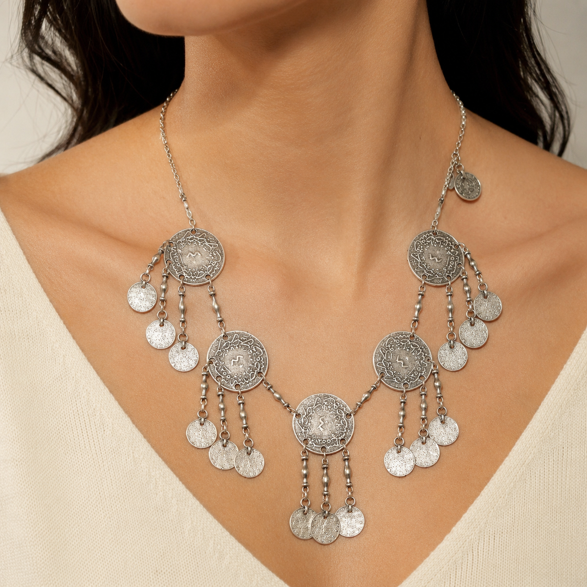 Silver-tone round coin fringe necklace with textured disc charms.