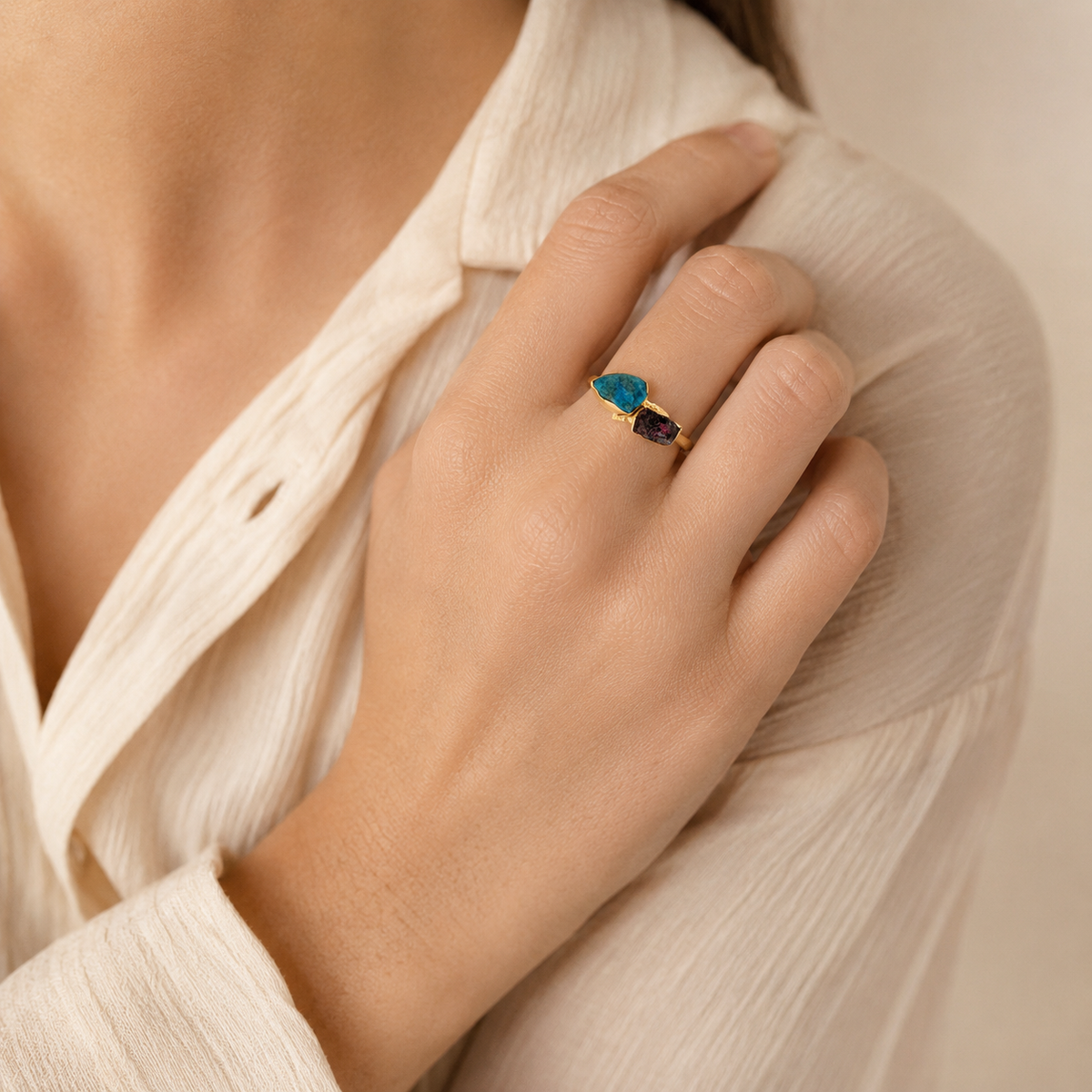 Raw apatite and garnet ring worn on a model.