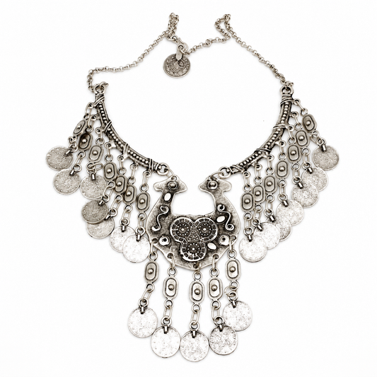 Silver-tone statement necklace with ornate coin fringe and layered charms.