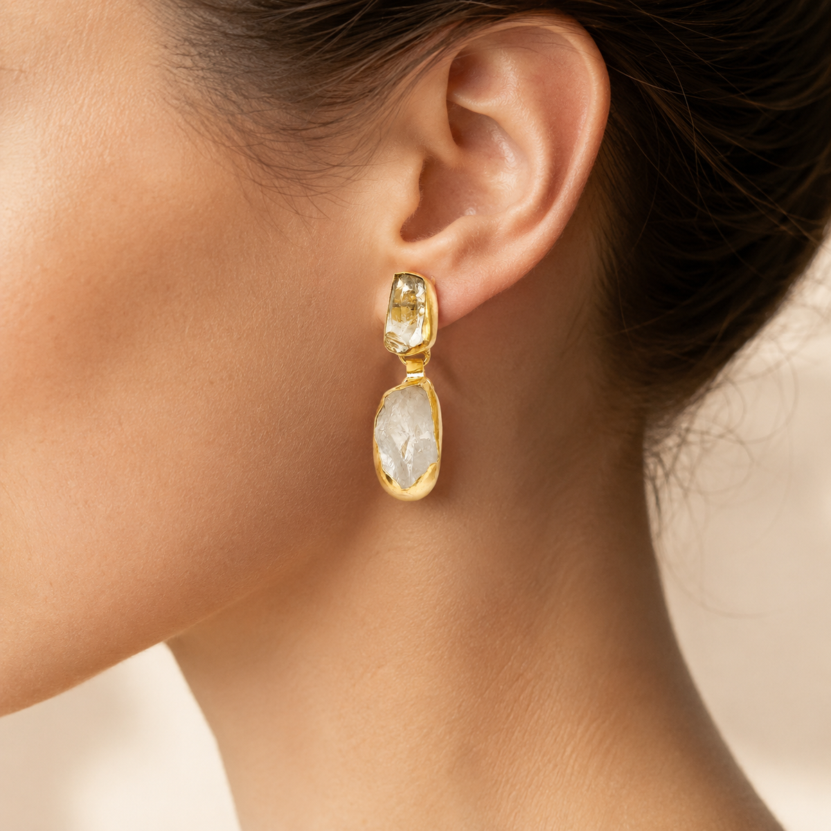 Gold-plated drop earrings with round pearl accents shown from the front.