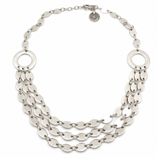 Layered silver-tone necklace with oval links and a sculptural multi-strand design.