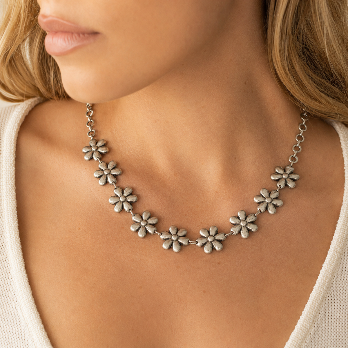 Silver-tone flower link necklace shown from the front on a white background.