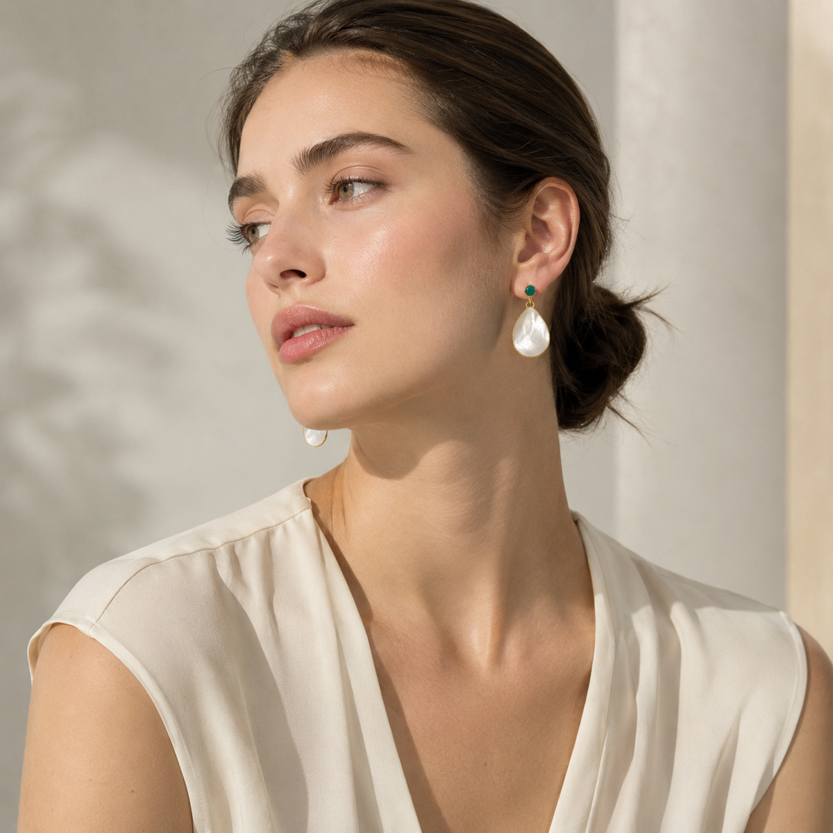 Gold plated drop earrings with a luminous mother of pearl teardrop.