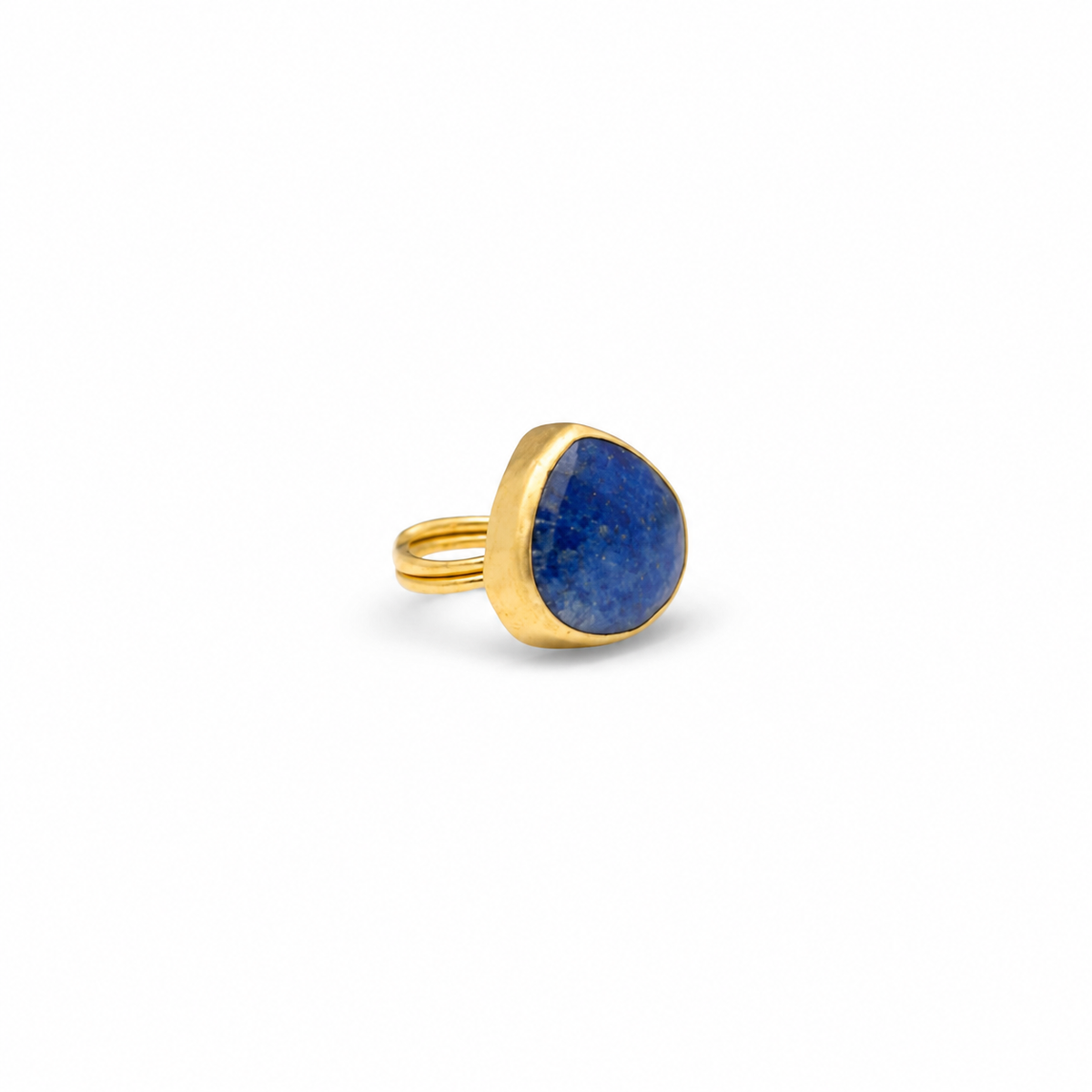 Gold-plated ring with a lapis blue teardrop stone on a white background.