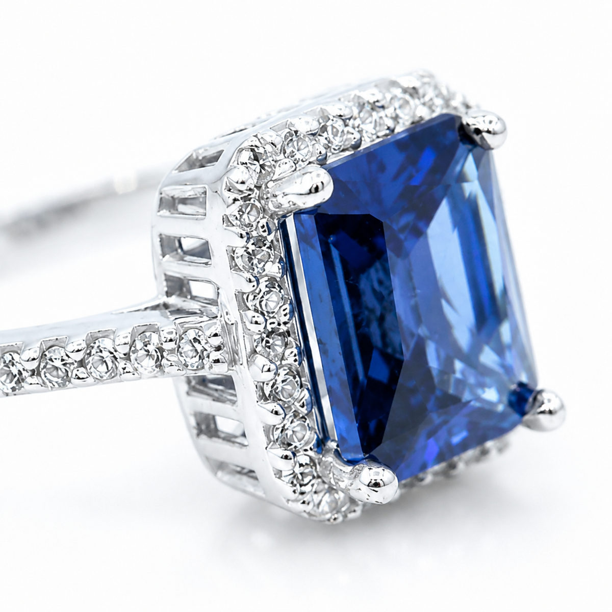 Close view of the blue sapphire center and sparkling setting on the ring.