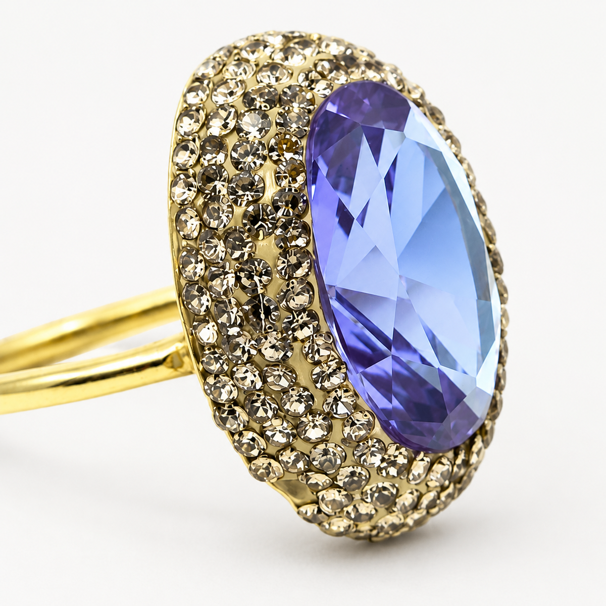 Close view of the faceted center stone and textured trim on the ring.