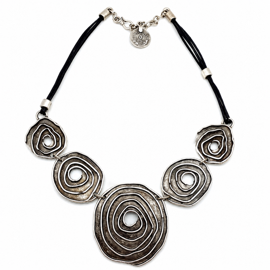 Black cord necklace with large spiral circle pendants and a polished metallic finish.