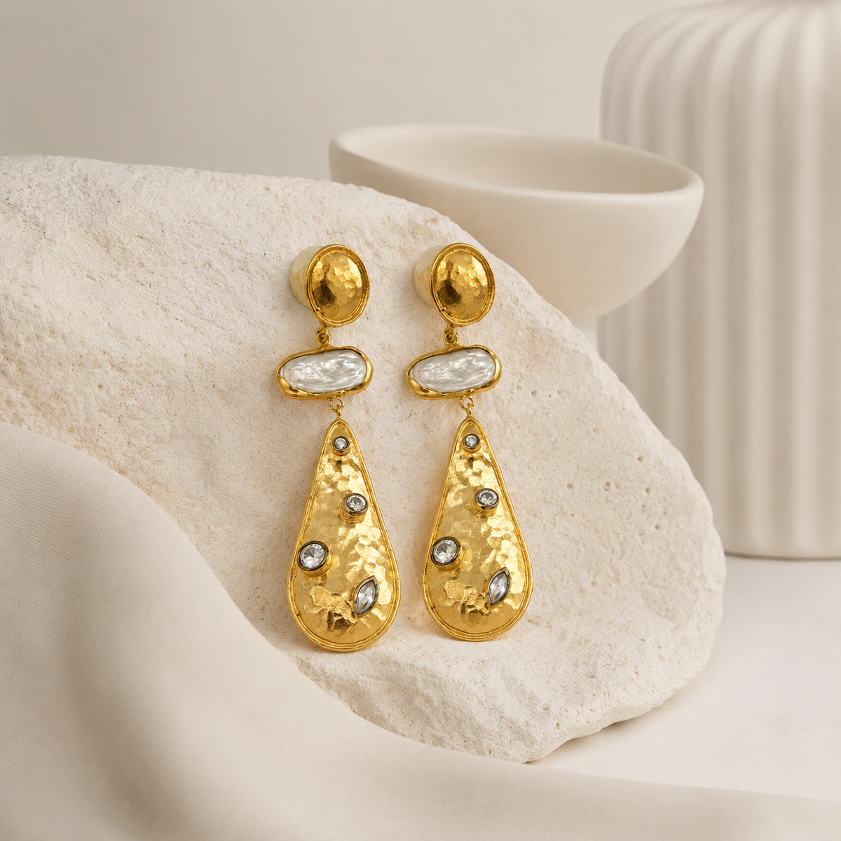 Gold drop earrings with a bold triple stone design.