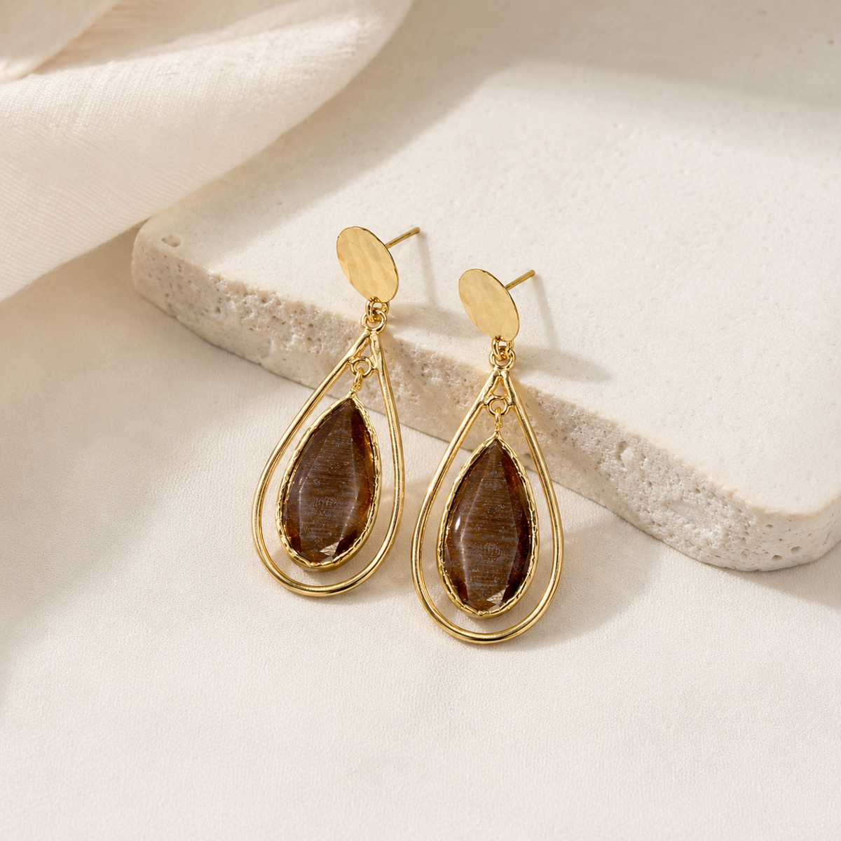 Brown teardrop drop earrings with a gold-plated cage silhouette.