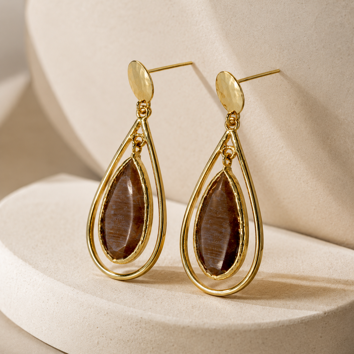 Brown teardrop drop earrings with a gold-plated cage silhouette.