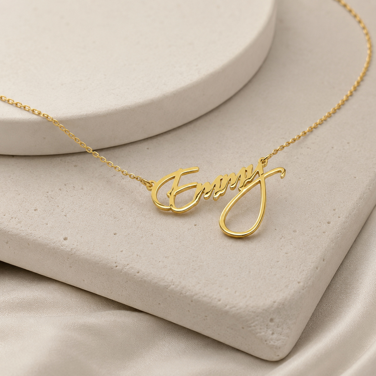 Angle view of a personalized name necklace in gold-tone metal.