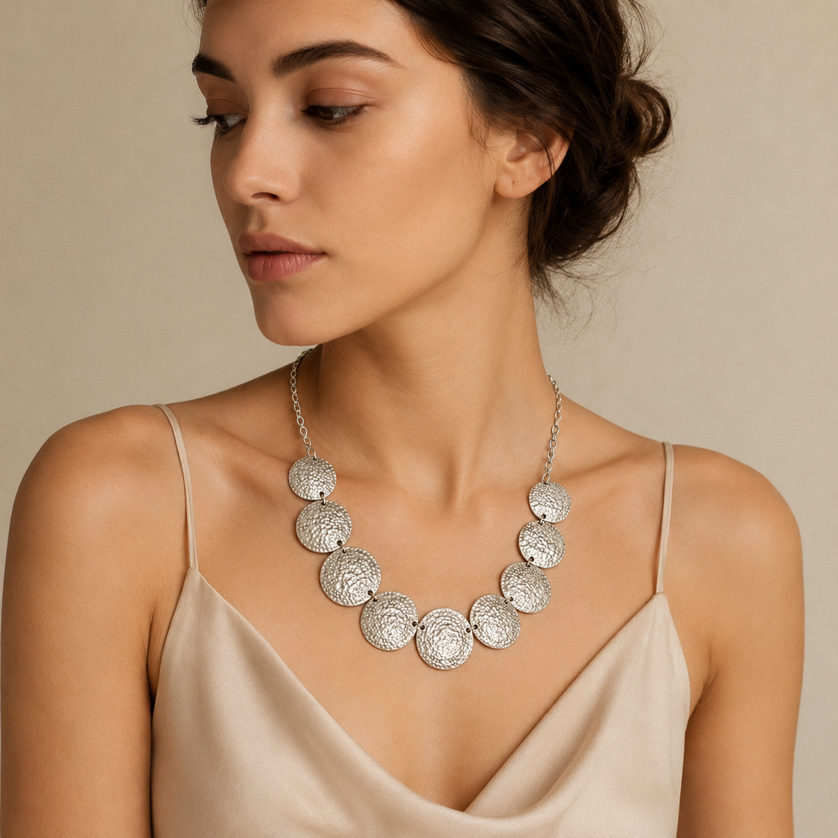 A bold necklace made of textured hammered discs.