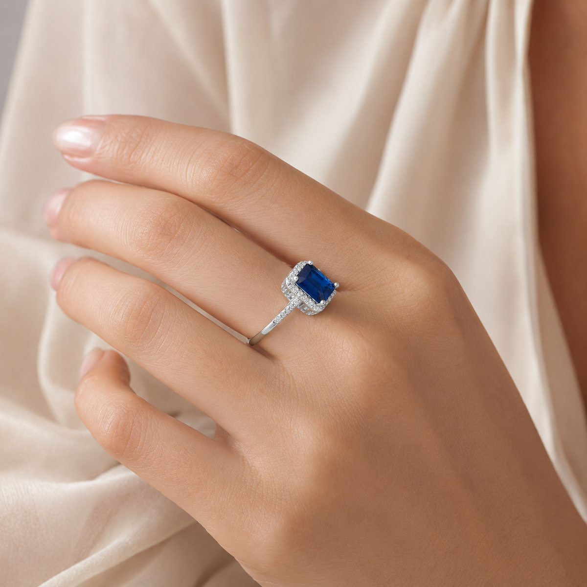 Cushion cut blue sapphire ring shown at an angle with a sleek silver-tone band.