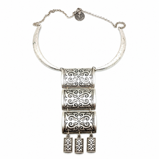 Silver-tone necklace with black enamel-inspired panel fringe pendant.