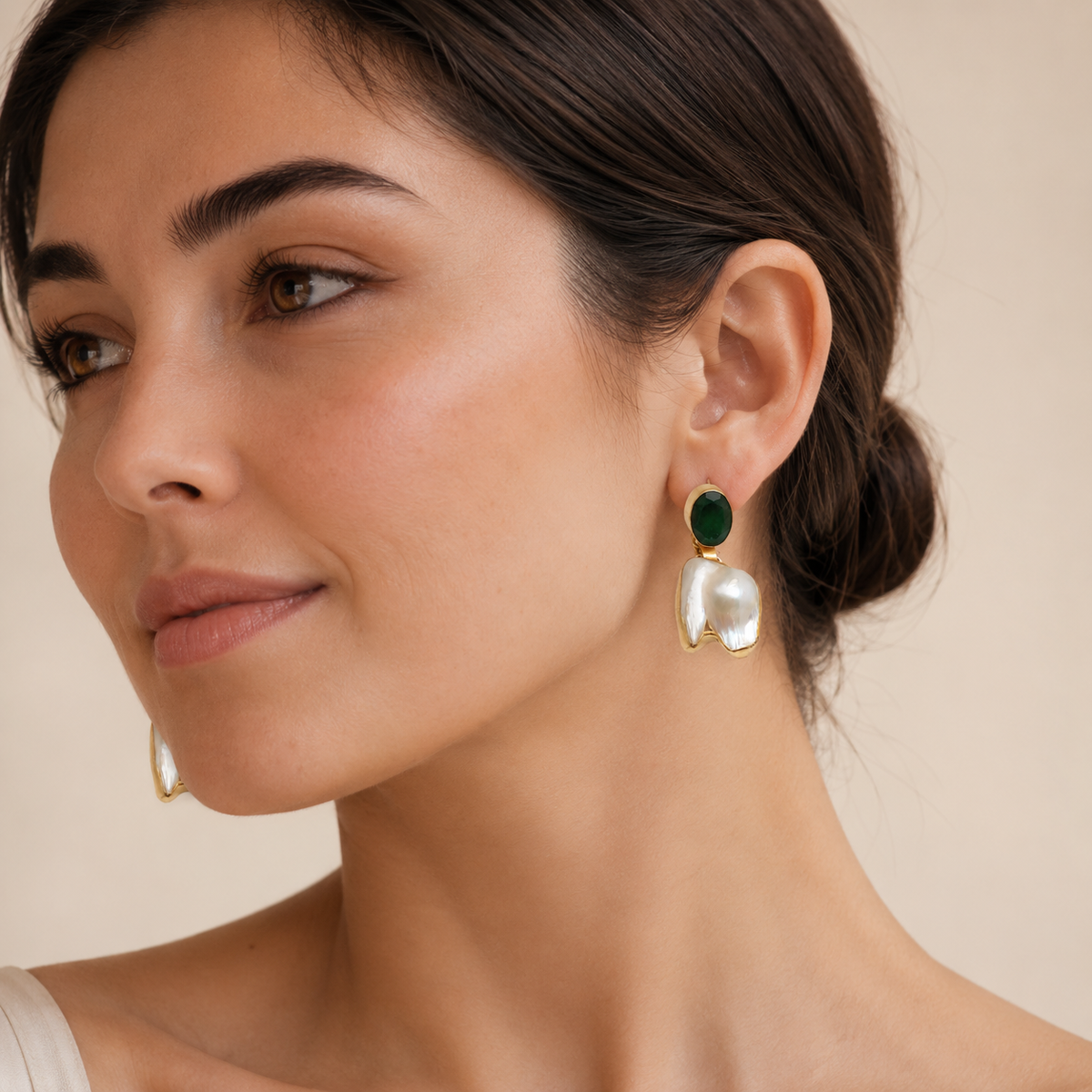 Pair of gold-tone drop earrings with green stones and irregular pearl drops.