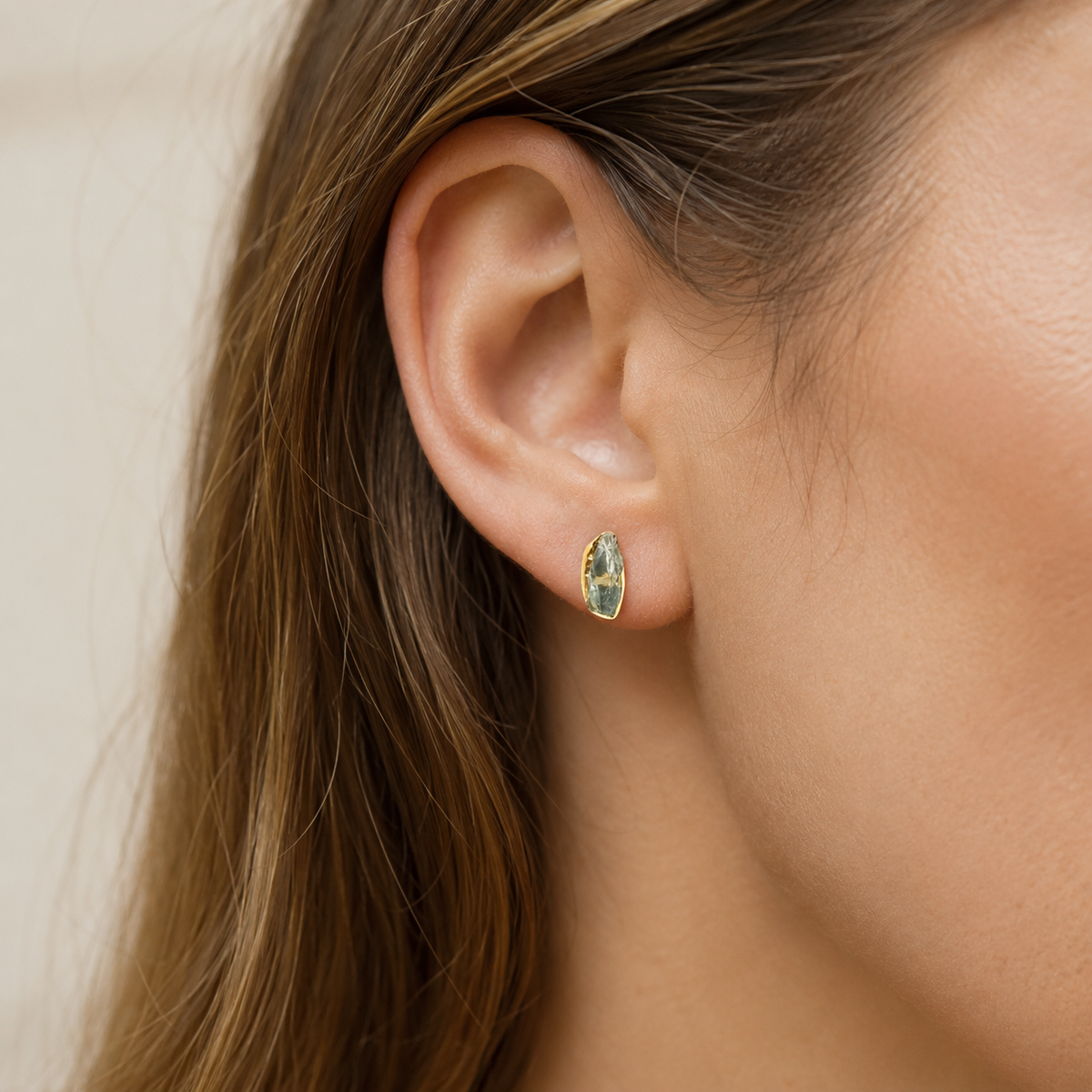 Raw green amethyst statement ring shown from the side with a gold-plated band.