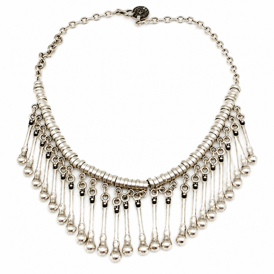 Silver-tone collar necklace with layered drop fringe and a polished finish.