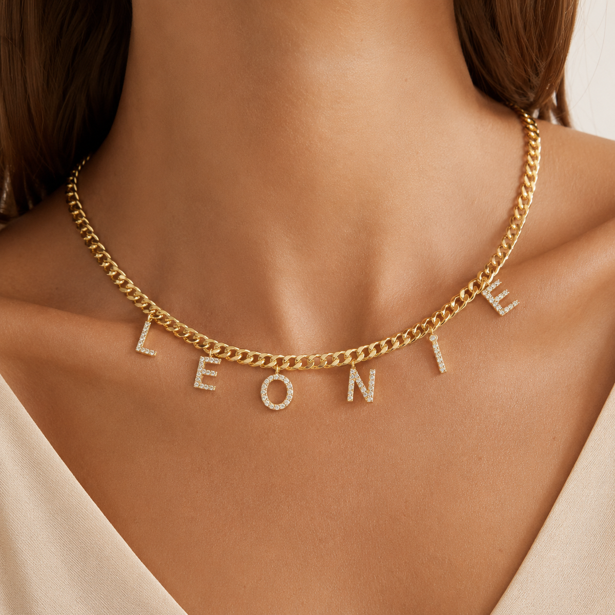 Gold-tone personalized necklace with sparkling CZ letter charms.