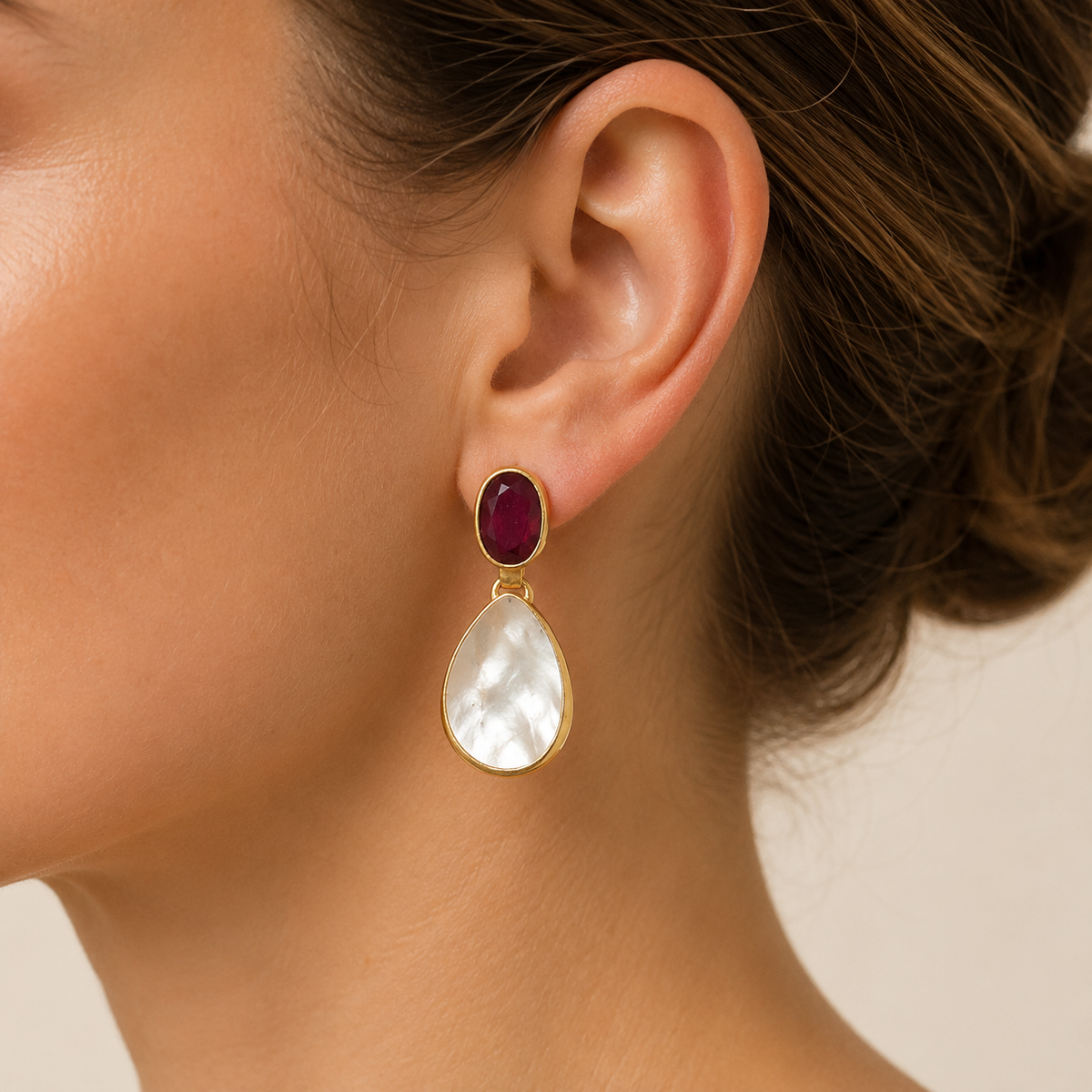 Gold-plated drop earrings with a deep red top stone and mother of pearl drop.