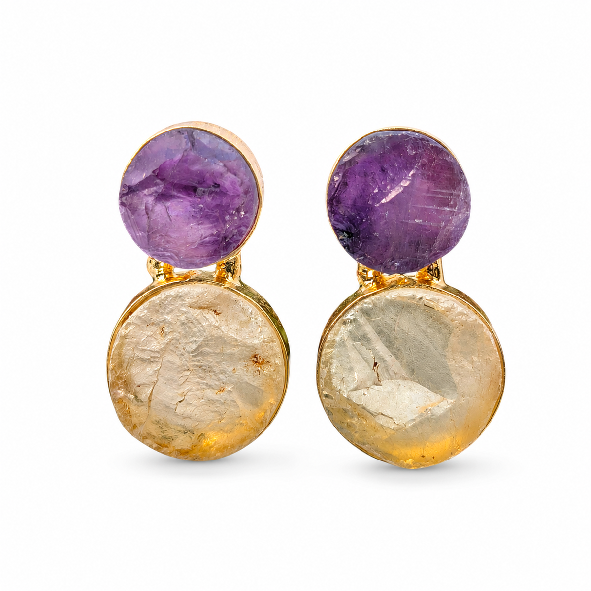 Pair of drop earrings with rough purple amethyst and clear quartz set in a gold-plated frame.