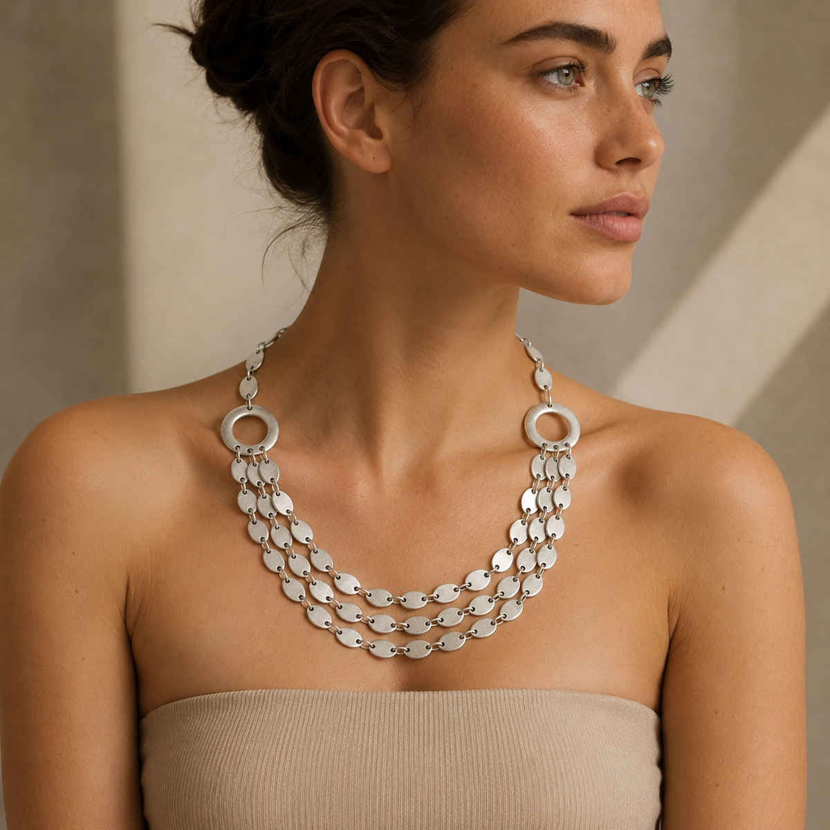 Silver-tone layered necklace with oval links and a statement silhouette.