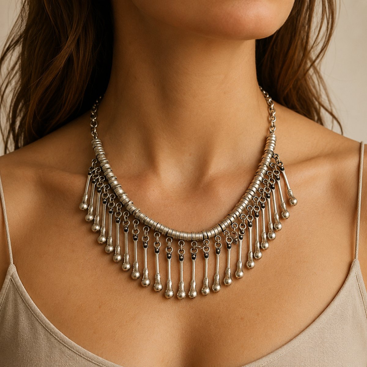 Silver-tone fringe necklace with a sculptural collar shape.