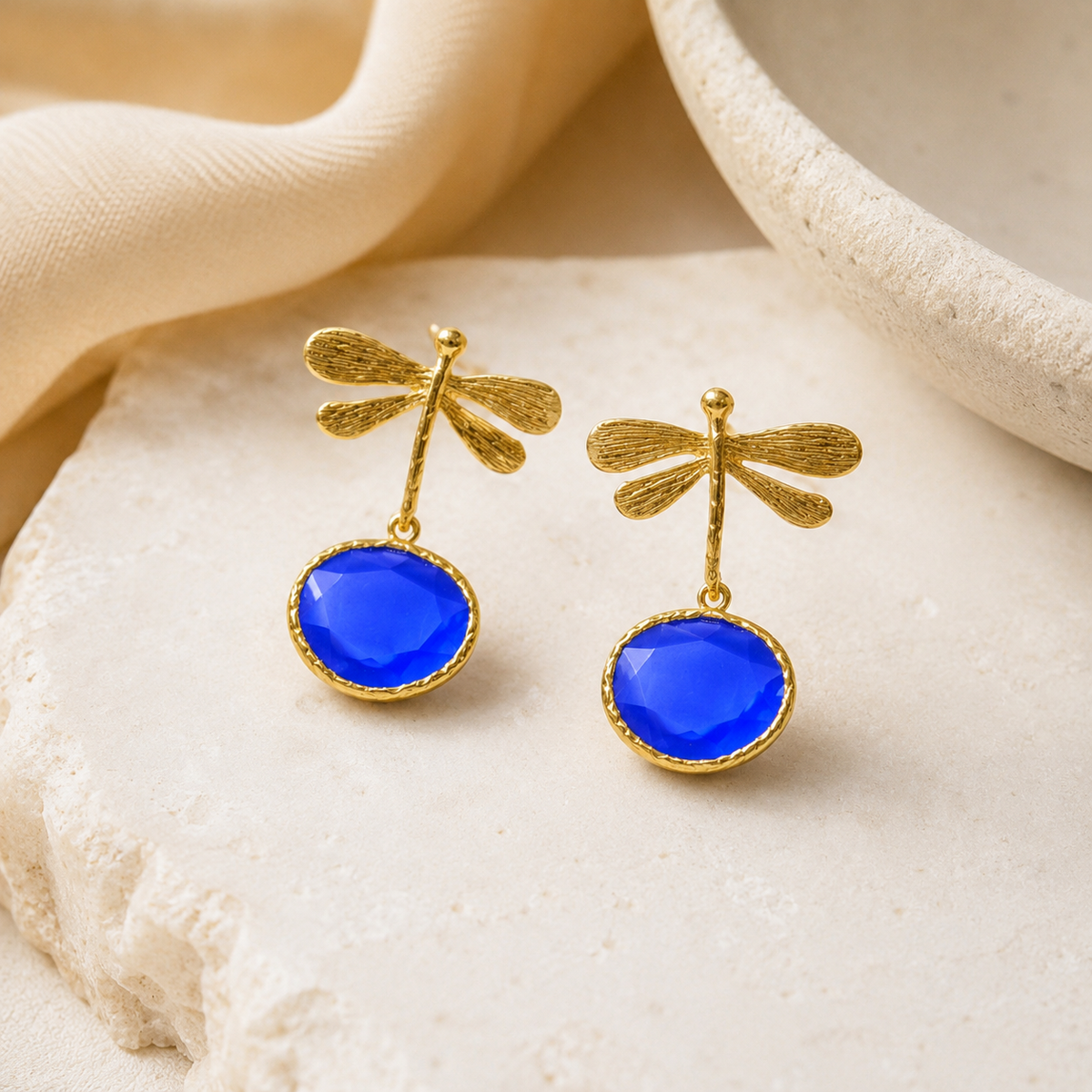 Blue dragonfly drop earrings with a polished gold-plated finish.
