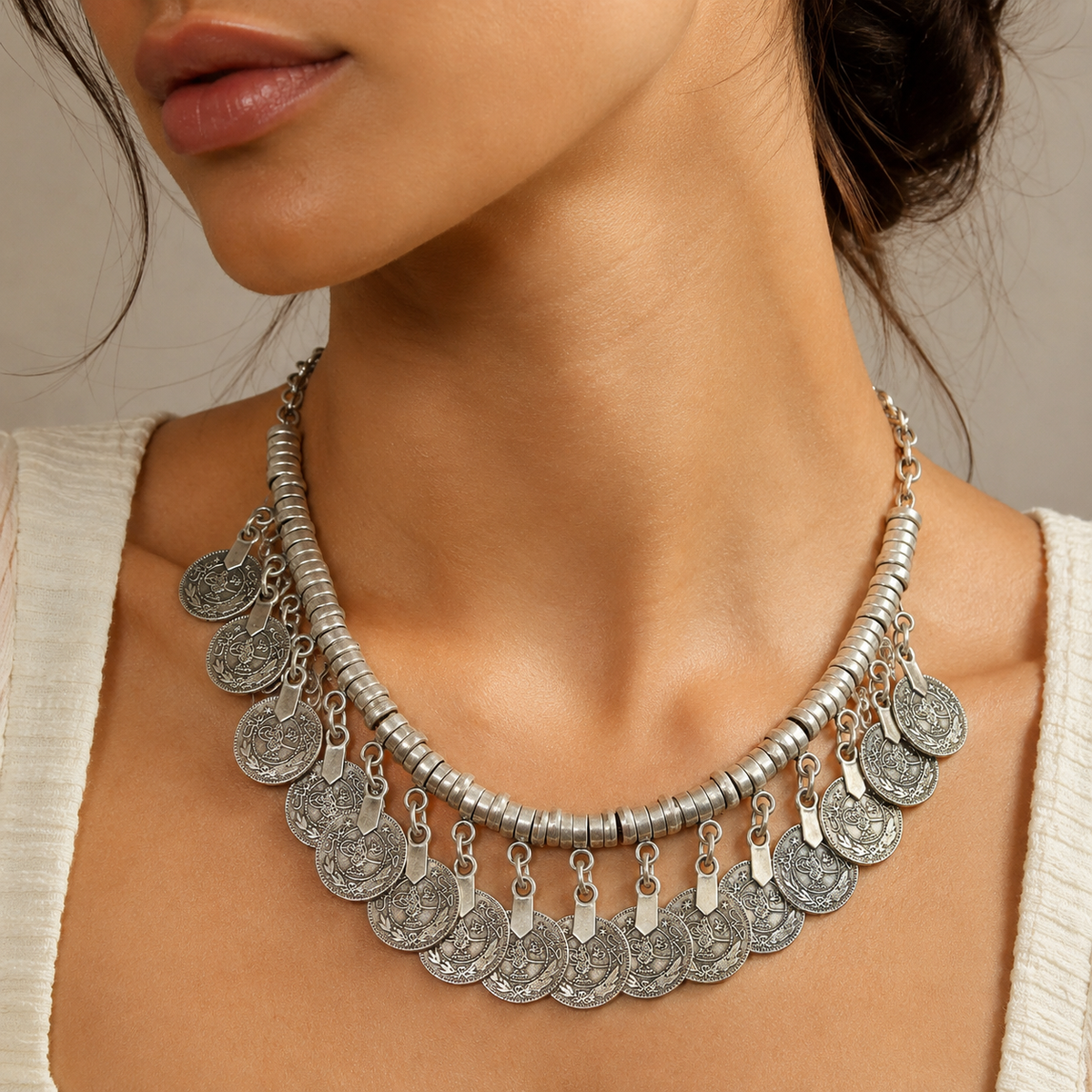 Silver-tone disc coin fringe collar necklace shown on a white background.