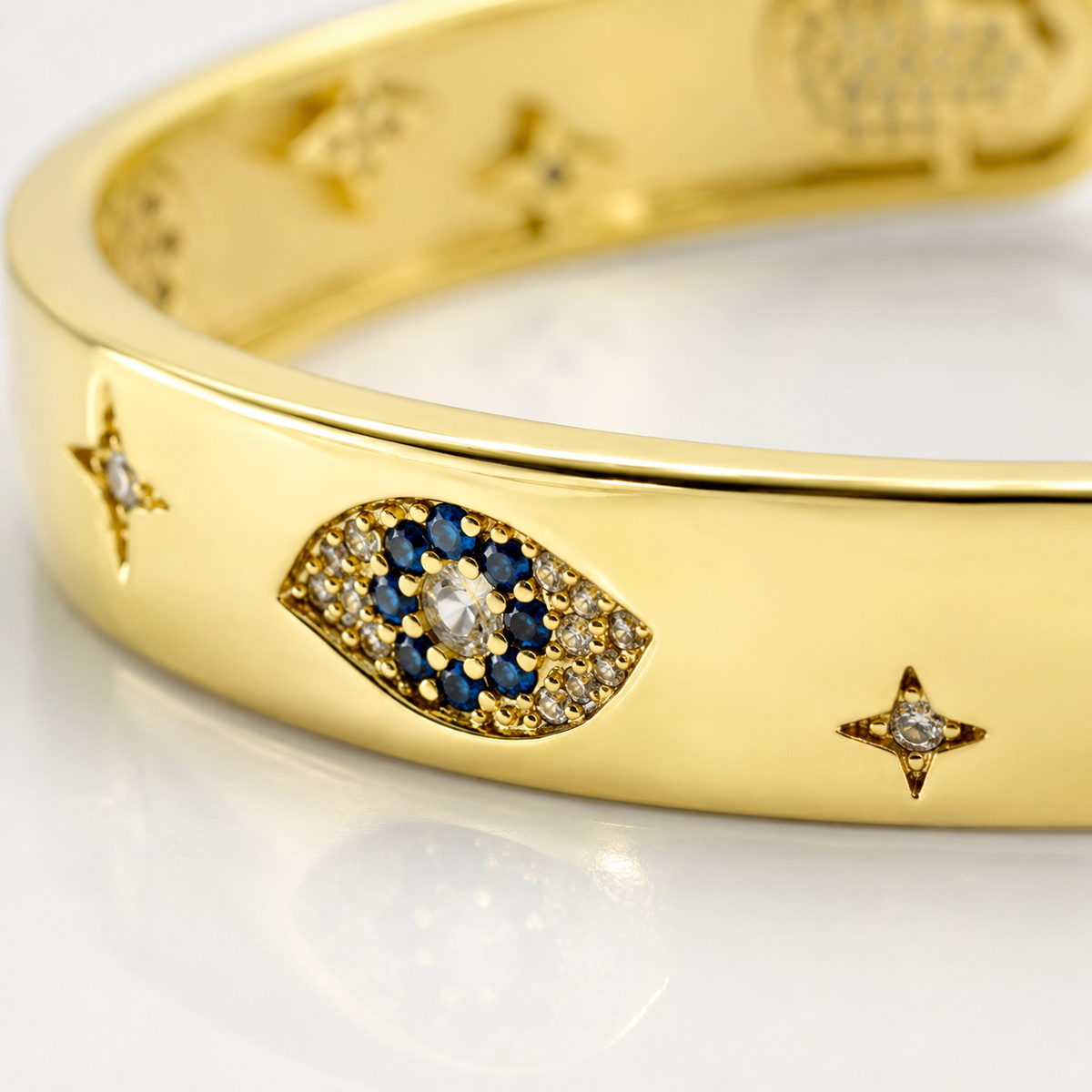 Close view of the bracelet’s polished gold-tone finish and patterned accents.