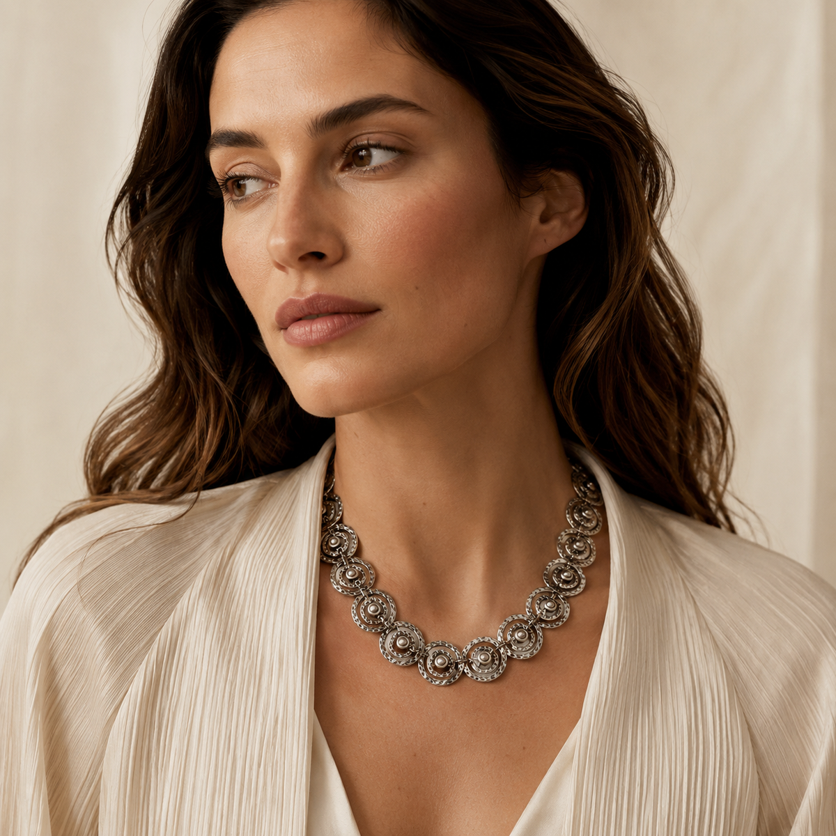Silver-tone spiral disc necklace with a bold linked design and polished shine.