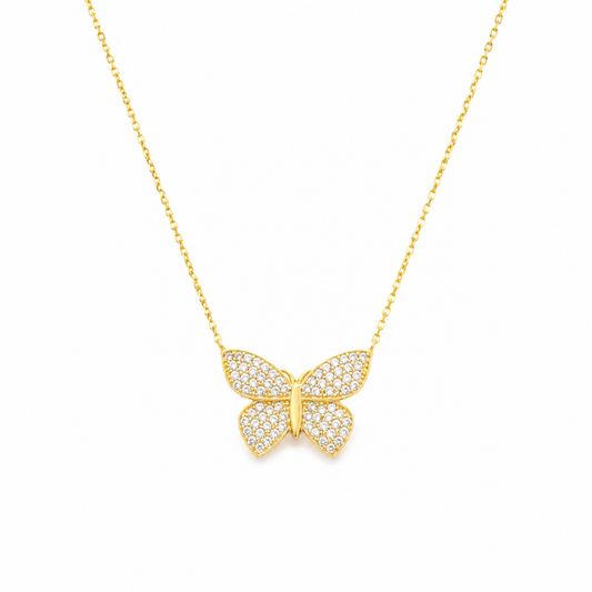 Gold-tone butterfly pendant necklace with sparkling detail on a fine chain.