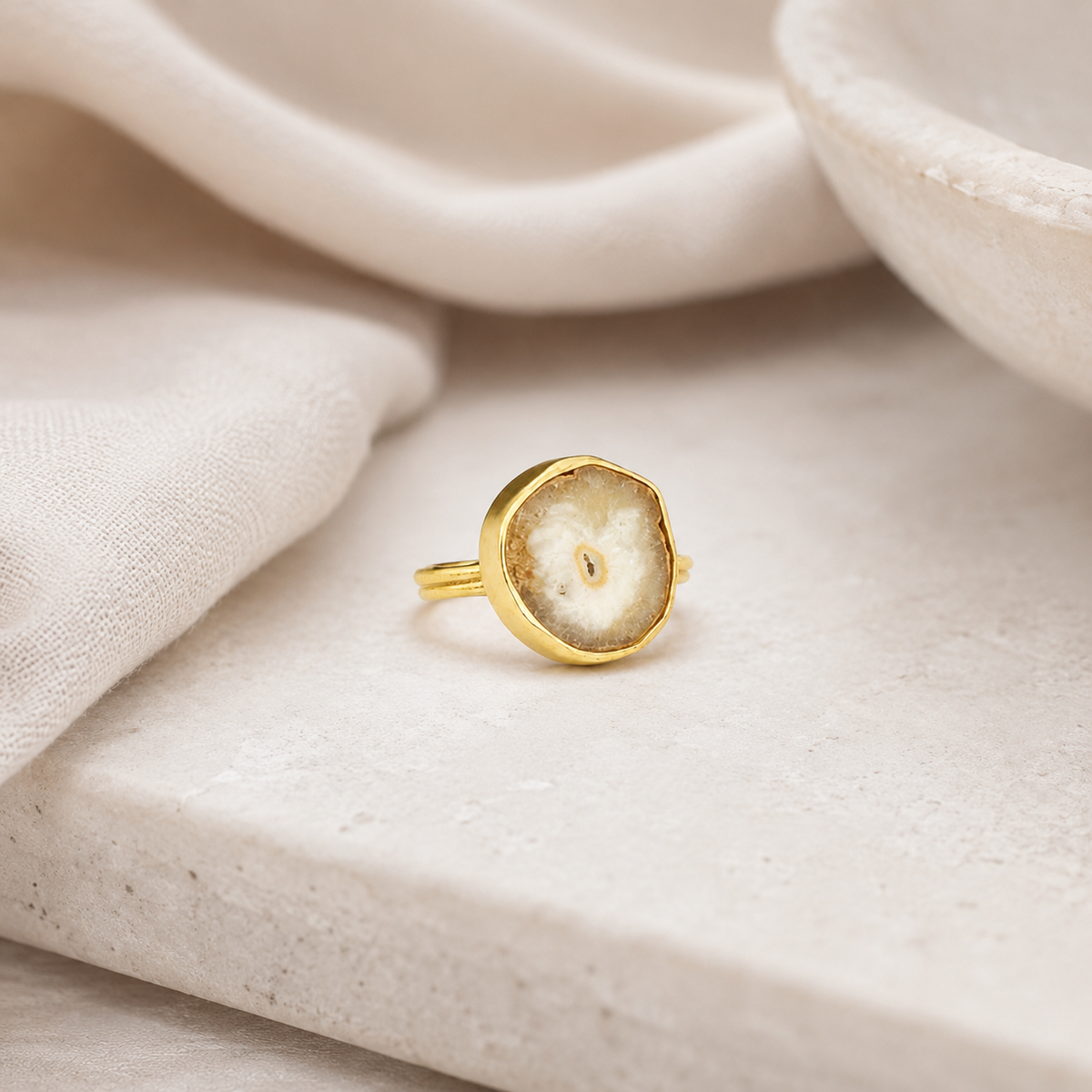 Gold-tone ring with an organic quartz slice shape.
