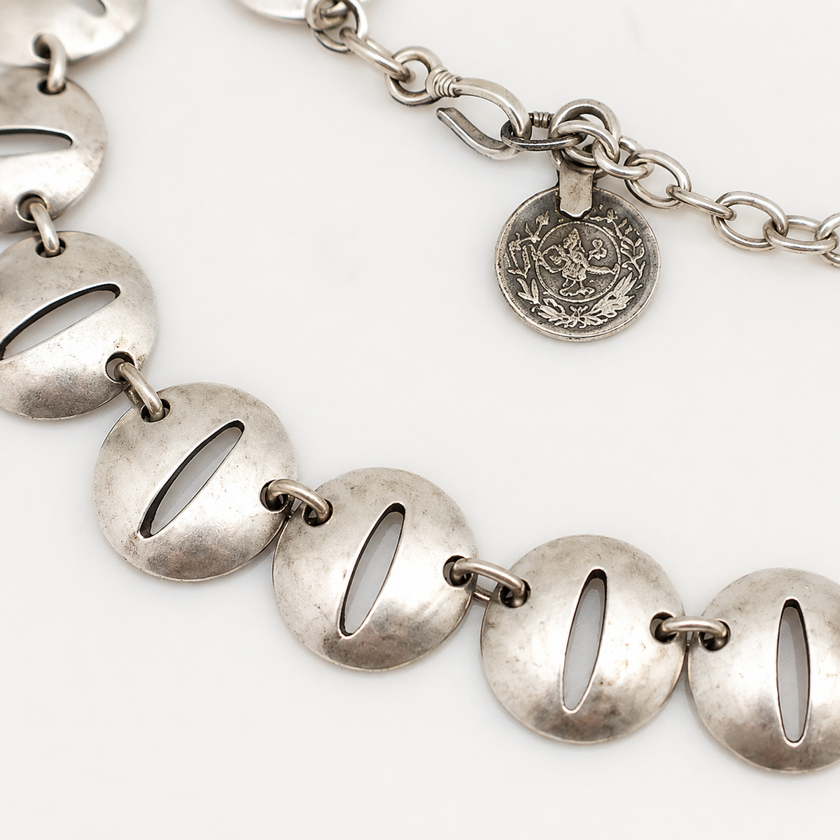 Close view of the polished oval disc links and chain detail.