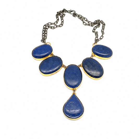 A statement necklace with blue oval stones, gold-tone frames, and a teardrop pendant.