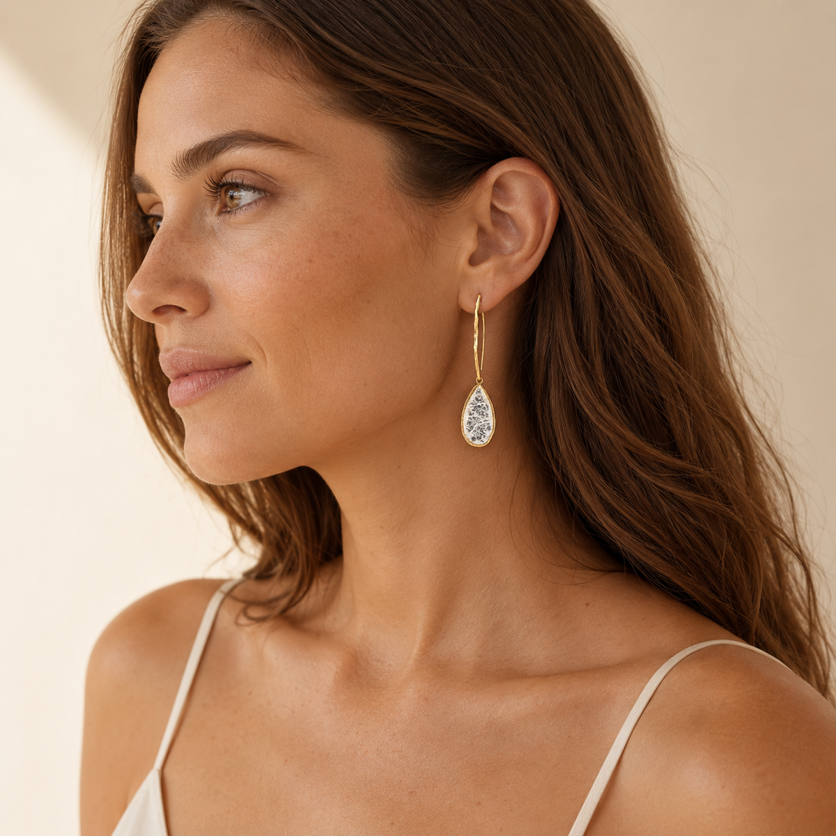 Gold-plated hook earrings with a cracked crystal-style teardrop design.
