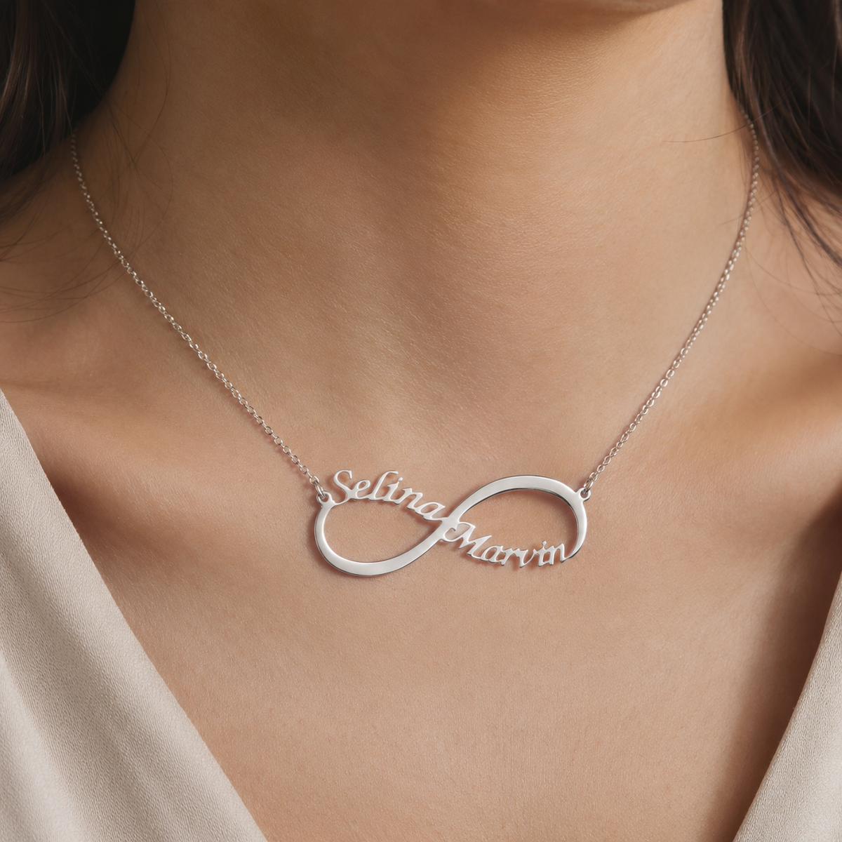 Close view of a personalized infinity necklace in a silver-tone finish.
