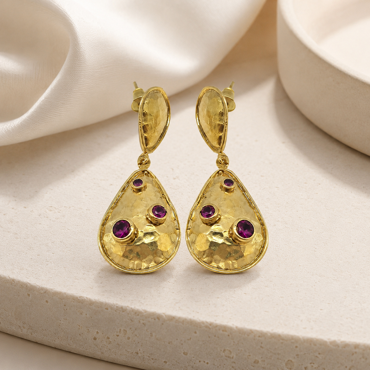 Gold-plated teardrop earrings with clear crystal accents in a clean product image.