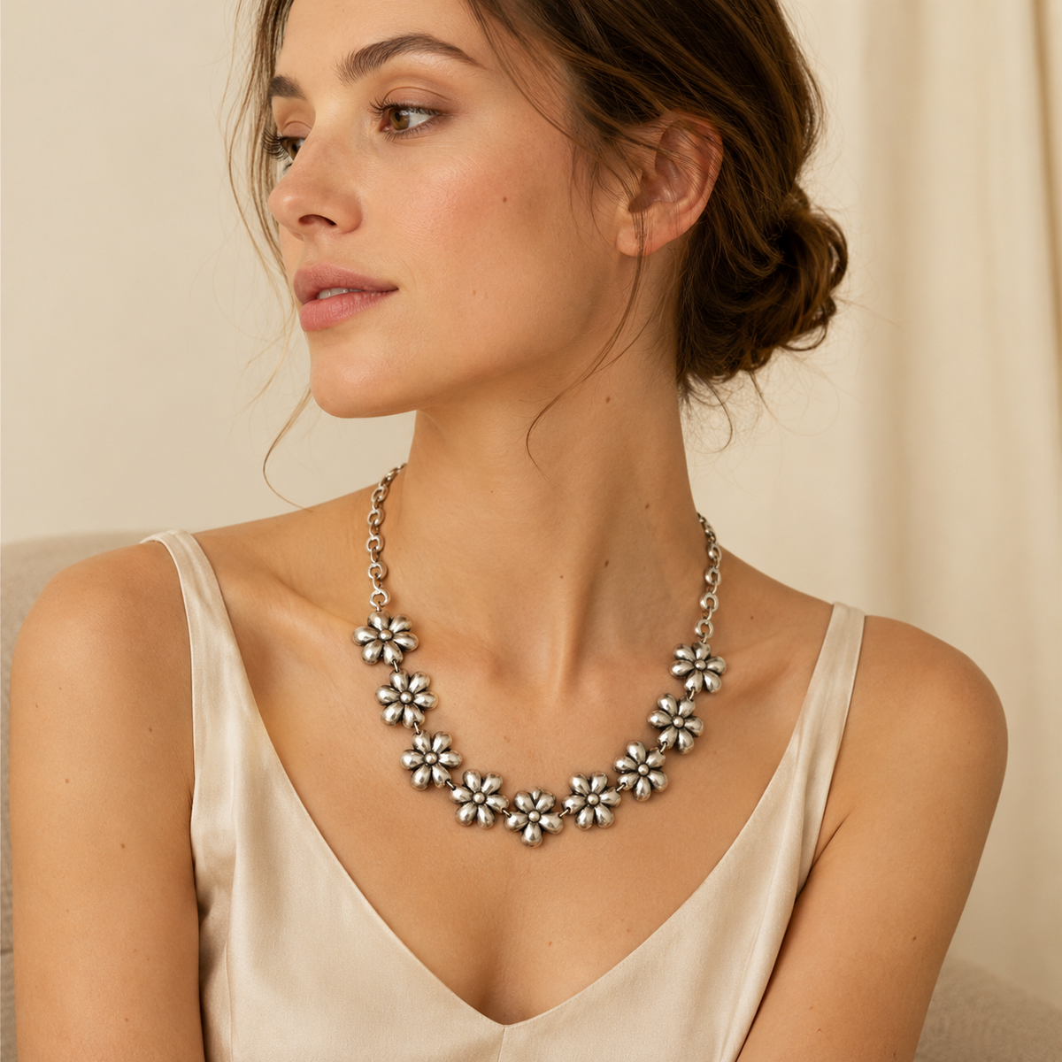 Silver-tone flower link necklace with a sculptural floral design.