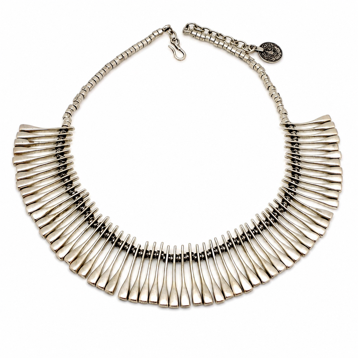 Silver-tone ribbed fan collar necklace with a sculptural statement shape.