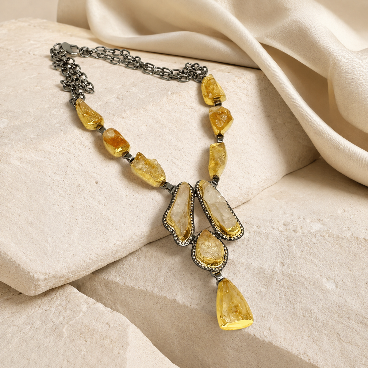 Angled view of the citrine raw crystal Y necklace with textured stones.