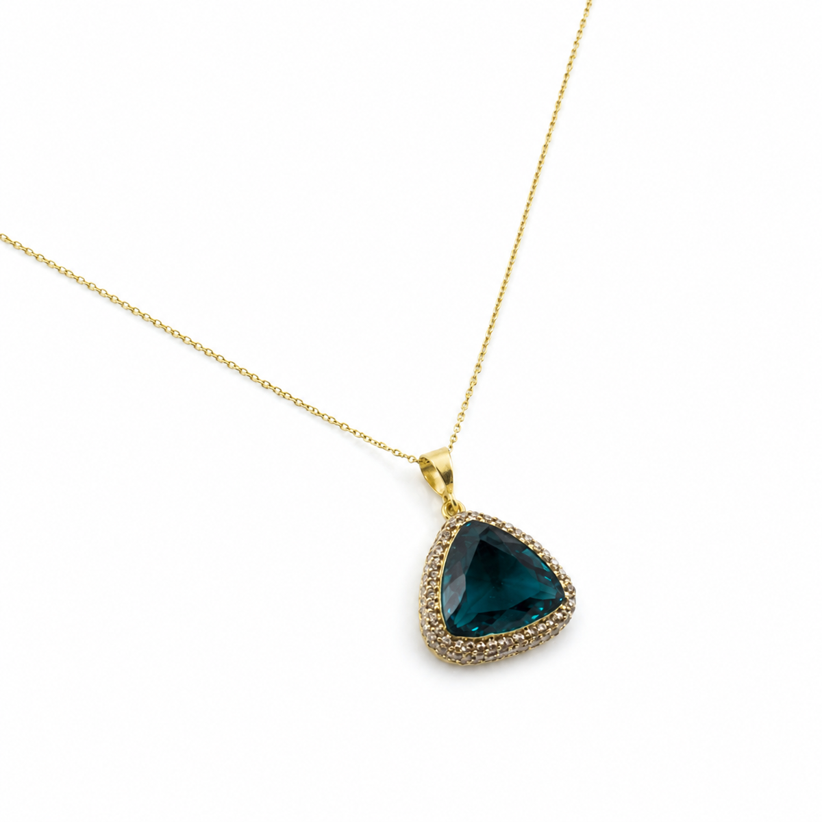 Angled view of a gold-tone necklace with a green triangle pendant.