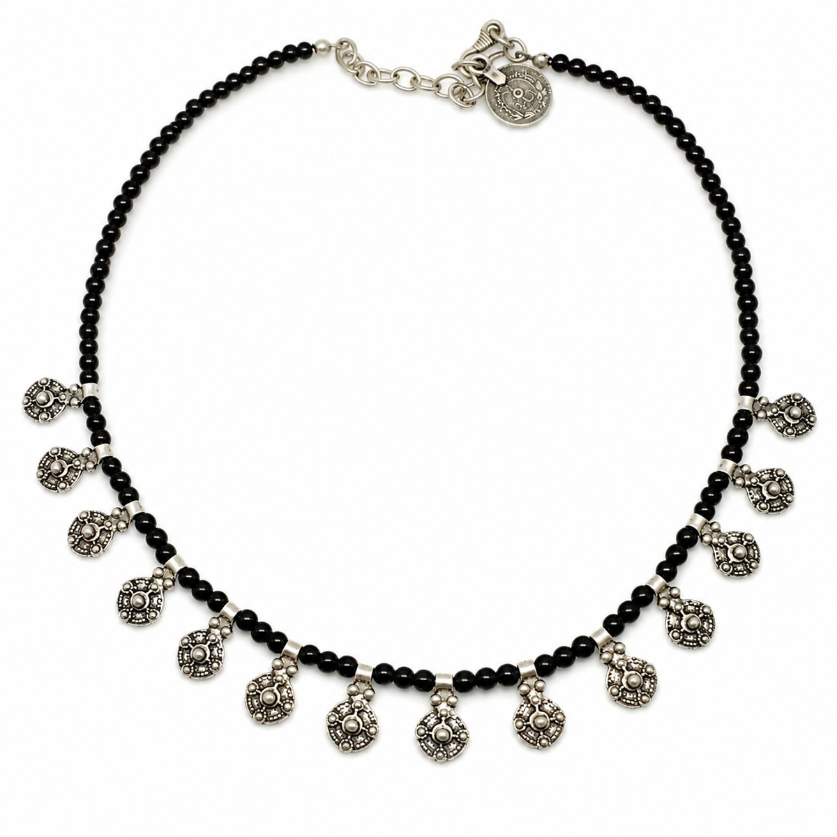 Black bead necklace with oval charm drops and silver-tone accents on a white background.