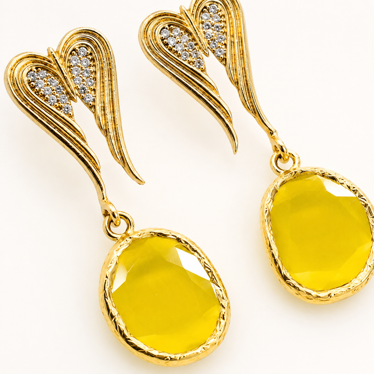 Close view of the heart-shaped earrings with black crystal detail.
